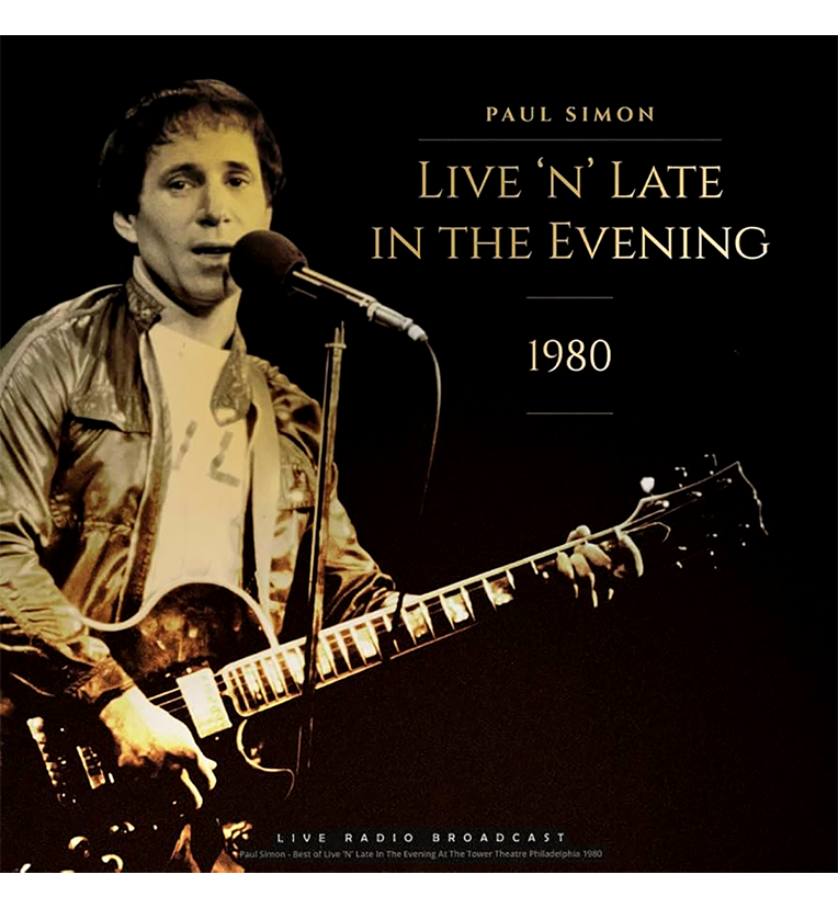 Vinyl record front cover for 'Paul Simon – Live 'n' Late in the Evening 1980.' The cover features a classic photo of Paul Simon performing live with a guitar and a microphone. The background is dark, highlighting Simon under the stage lights. The title text 'Paul Simon Live 'n' Late in the Evening 1980' is displayed prominently in elegant font. The bottom text notes 'Live Radio Broadcast' with details about the performance recorded at The Tower Theatre in Philadelphia, 1980.