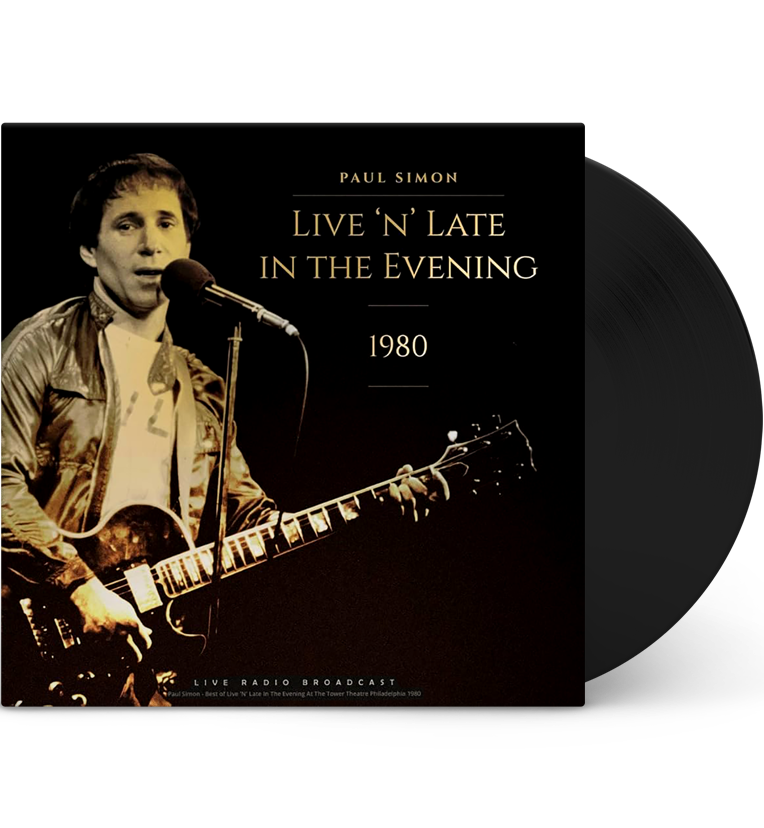 Vinyl record front cover for 'Paul Simon – Live 'n' Late in the Evening 1980.' The cover features a classic photo of Paul Simon performing live with a guitar and a microphone. The background is dark, highlighting Simon under the stage lights. The title text 'Paul Simon Live 'n' Late in the Evening 1980' is displayed prominently in elegant font. The bottom text notes 'Live Radio Broadcast' with details about the performance recorded at The Tower Theatre in Philadelphia, 1980.