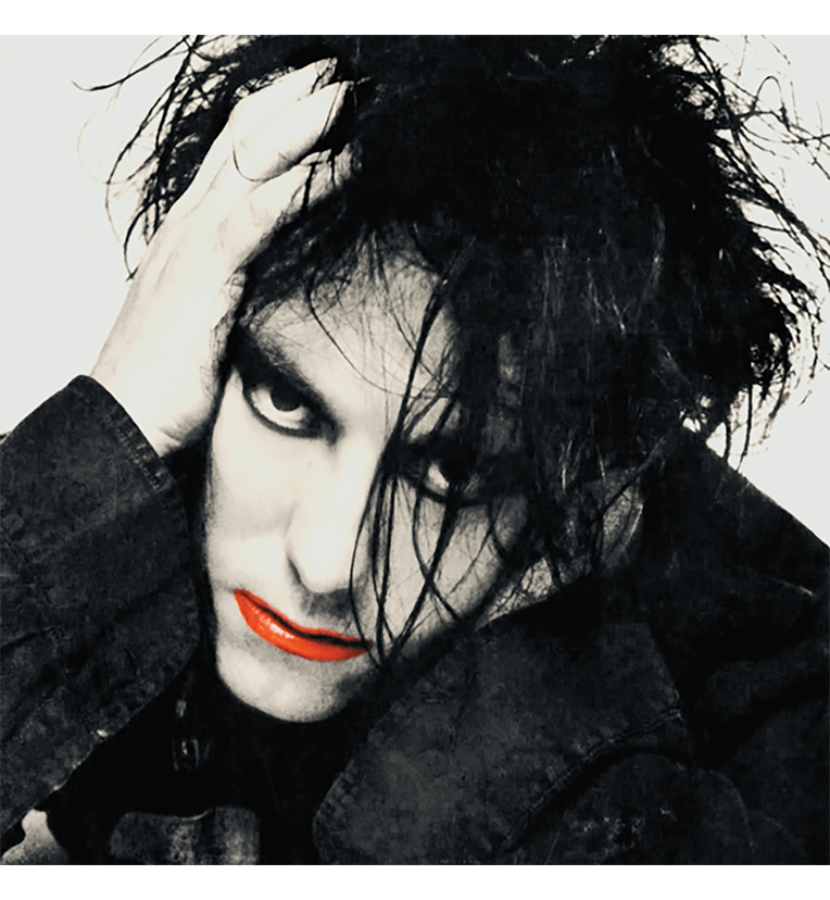 Front cover of the vinyl record ‘The Cure – Live in Washington, D.C., 1984’. The cover displays a high-contrast black and white portrait of Robert Smith with wild, dark hair and heavy eyeliner. His face partially covered by his hand, which rests on his head. His lips are painted bright red, adding a splash of color to the monochromatic image.